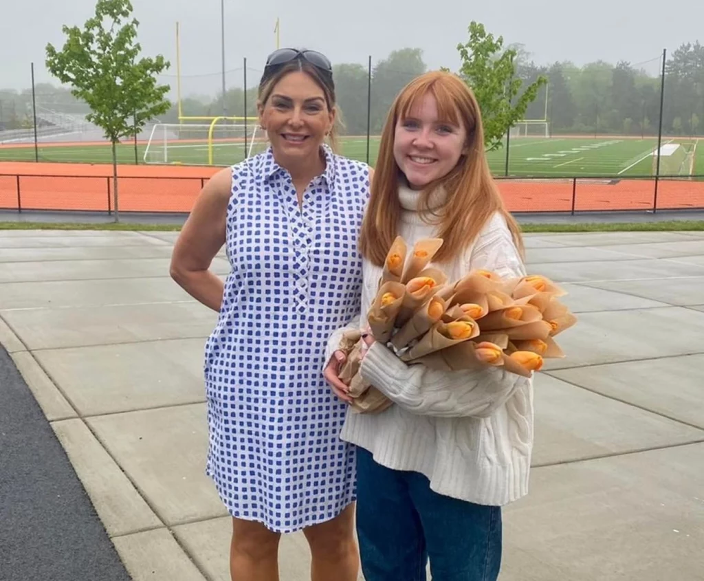 Catherine McGonagle, STEMS Co-Founder & President, holding orange tulips