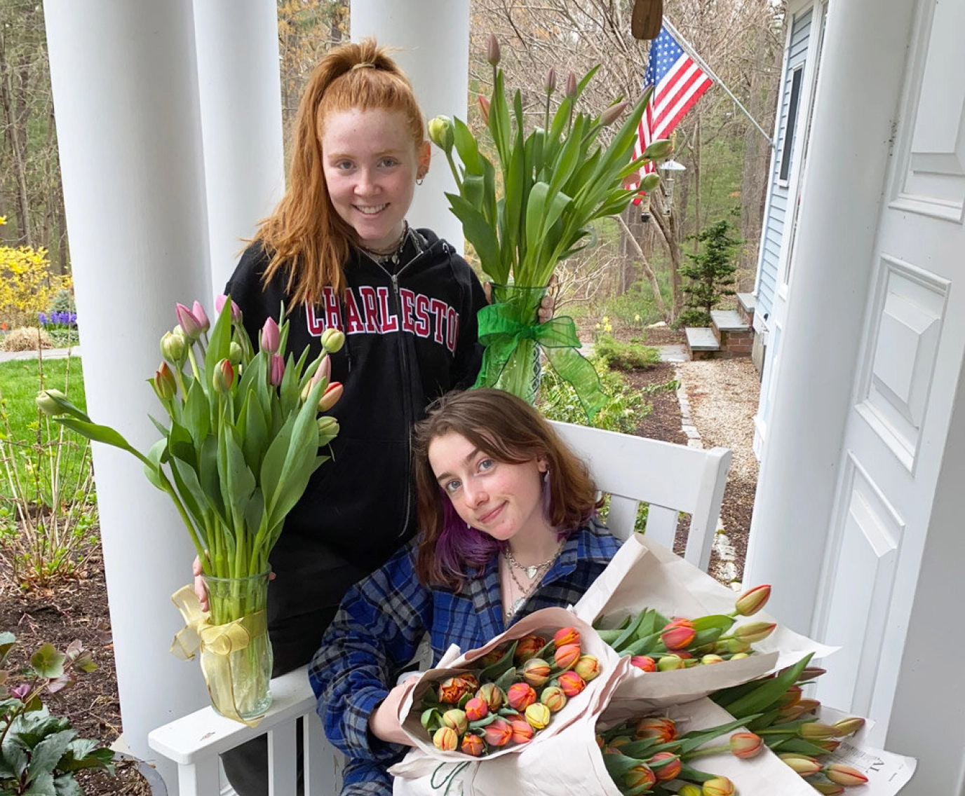 Catherine McGonagle, STEMS Co-Founder & President, and STEMS volunteer, holding bouquets of tulips